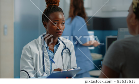 Close up of medic writing information on checkup papers 83635615