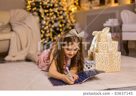 Cute little child girl writes the letter to Santa Claus 83637145