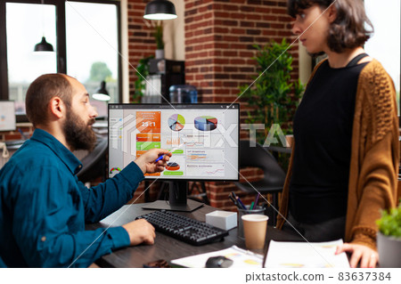 Businessman explaining marketing strategy to woman manager showing company data chart Businessman explaining marketing strategy to woman manager showing company data chart 83637384