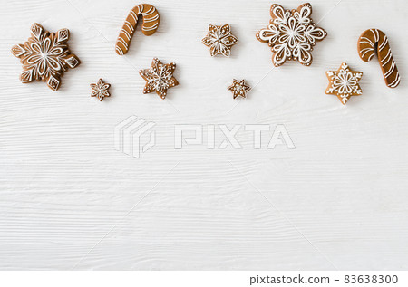 Christmas homemade gingerbread cookies on the white wooden background. Christmas homemade gingerbread cookies on the white wooden background. 83638300