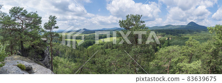 Panoramic view from sandstone rock viewpoint Havrani skaly, spring landscape in Lusatian Mountains with hill Klic, Kleis, green hills, fresh deciduous and spruce tree forest. Blue sky background, copy 83639675