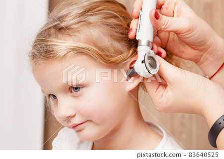 Child ENT check - doctor examining ear of a little girl with otoscope 83640525