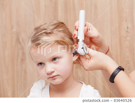 Child ENT check - doctor examining ear of a little girl with otoscope 83640526