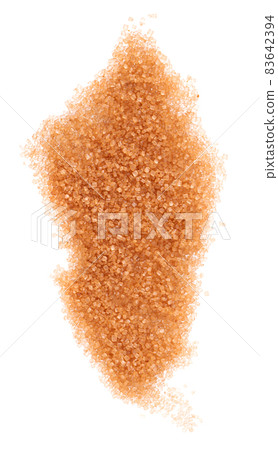 Brown sugar isolated on white background. Heap of cane sugar crystals. Top view. 83642394