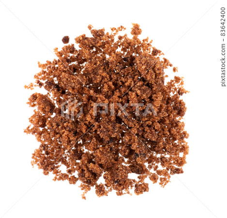 Muscovado sugar isolated on white background. Barbados sugar, khandsari or khand. Top view. Muscovado sugar isolated on white background. Barbados sugar, khandsari or khand. Top view. 83642400