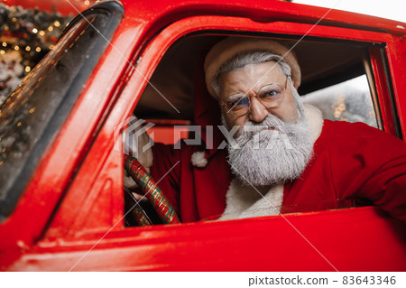 Portrait of an angry Santa Claus driving. Aggressive driver, new year, christmas. Santa Claus is 83643346