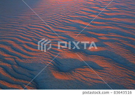 Wavy and narrow patterns in the sand before dawn 83643516
