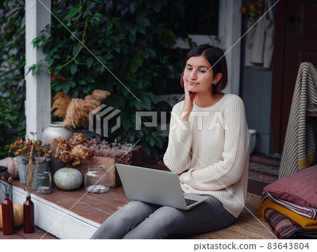 woman with laptop working outdoors in garden 83643804