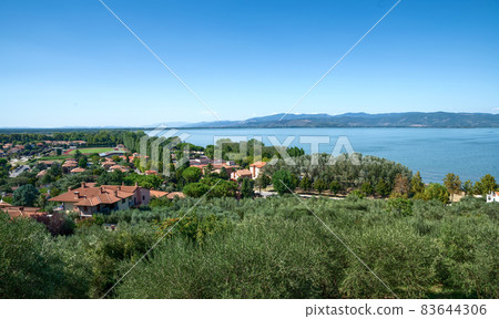 Castiglione del lago, Umbria, Italy. August 2020. Amazing landscape of the Trasimeno lakefront. From the top of the hill of the historic village the view is very wide. 83644306