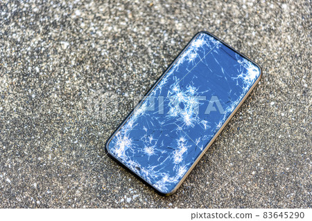 A smartphone with a broken screen when dropped 83645290