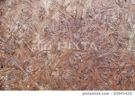 Fiberboard. Compressed light brown wooden texture 83645420