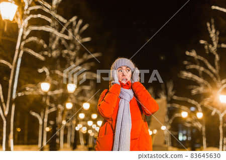 Girl in a night city snowflake Christmas city lights. Christmas and winter holidays concept. 83645630