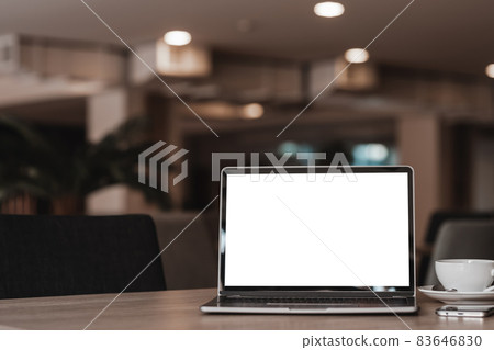 Mockup of laptop computer with empty screen with coffee cup and smartphone on table of the coffee shop background,White screen Mockup of laptop computer with empty screen with coffee cup and smartphone on table of the coffee shop background,White screen 83646830