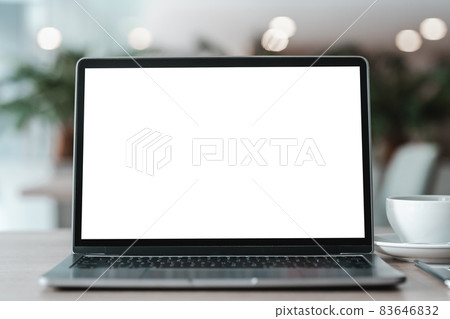 Mockup of laptop computer with empty screen with coffee cup and smartphone on table of the coffee shop background,White screen Mockup of laptop computer with empty screen with coffee cup and smartphone on table of the coffee shop background,White screen 83646832