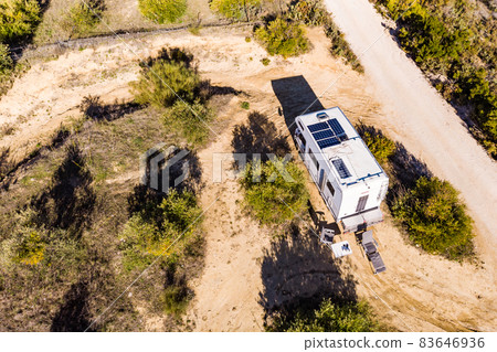 Caravans with solar panels on roof camping on nature. Caravans with solar panels on roof camping on nature. 83646936