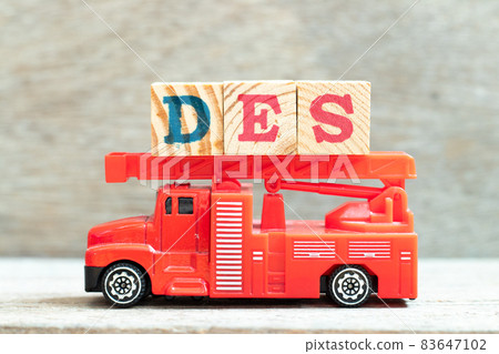 Fire ladder truck hold letter block in word DES (Abbreviation of Delivered Ex Ship) on wood background Fire ladder truck hold letter block in word DES (Abbreviation of Delivered Ex Ship) on wood background 83647102
