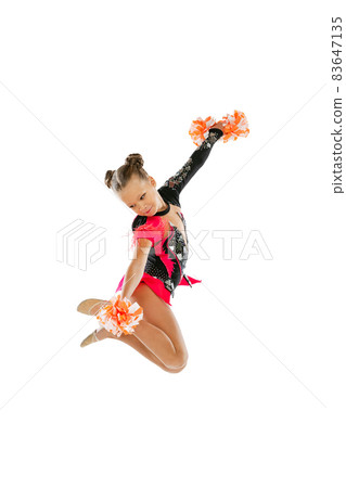 Full-length portrait of girl, child training cheerleadin, jumping isolated over white background 83647135