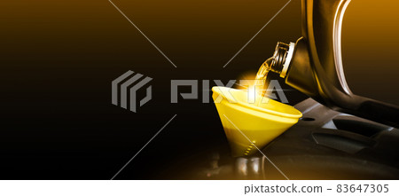 Mechanic pouring motor oil to engine with horizontal copy space on black background 83647305