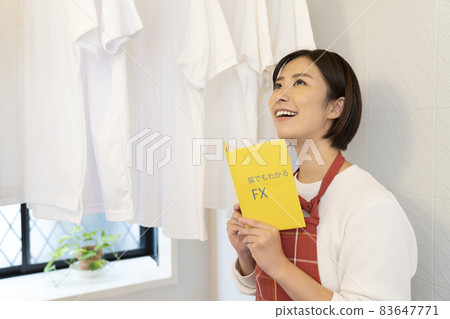 A woman reading a shirt and FX book dried in the bathroom A woman reading a shirt and FX book dried in the bathroom 83647771
