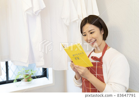 A woman reading a shirt and FX book dried in the bathroom A woman reading a shirt and FX book dried in the bathroom 83647791