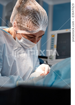 The surgeon cuts the eyelid and performs manipulations using medical instruments. Blepharoplasty. The surgeon cuts the eyelid and performs manipulations using medical instruments. Blepharoplasty. 83647829