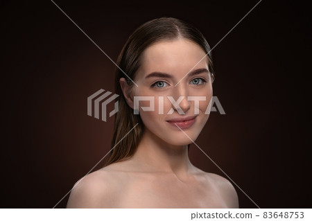 Headshot portrait of happy girl with natural make up and bare shoulders. Healthy pure skin model isolated on black background. Natural make up concept. Spa and beautiful concept 83648753