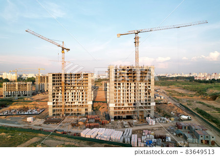 Crane during formworks on construction site. Pouring concrete into formwork.  83649513