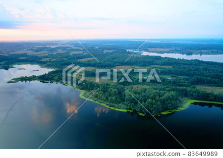 Lake among green trees in the countryside. Lake among green trees in the countryside. 83649989