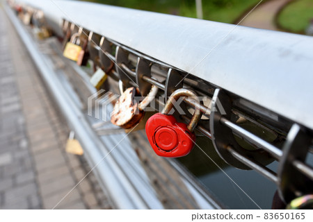 Padlock on Lovers Lock Bridge. Husband and wife during the wedding hung a padlock  83650165