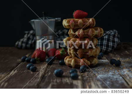 coffee pot with brewed coffee and some waffles on wooden board coffee pot with brewed coffee and some waffles on wooden board 83650249
