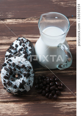 jug of milk with some donuts for breakfast 83650354