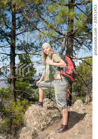 female hikers at the top of a mountain with her backpack 83651453