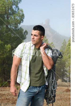 man with ropes prepared to climb 83651473
