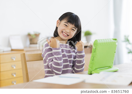 Girl elementary school student studying on a tablet PC 83651760