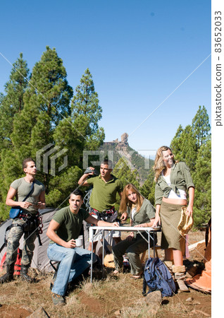 group of hikers in their huts among the pines.  83652033