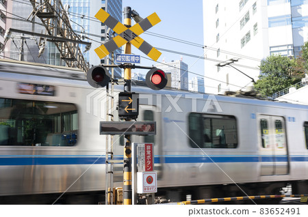 Scenery of a train passing through a railroad crossing 83652491