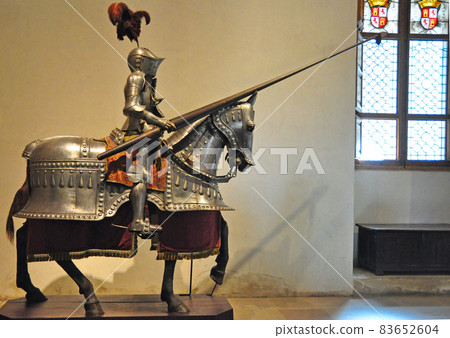 A knight riding in the entrance armor of Alcazar Castle, Segovia, Spain 83652604