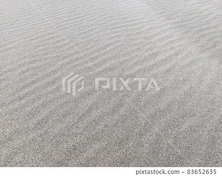 Stock photo: Sandbox on the beach leaves the shape of the wind in a wavy shape 83652635