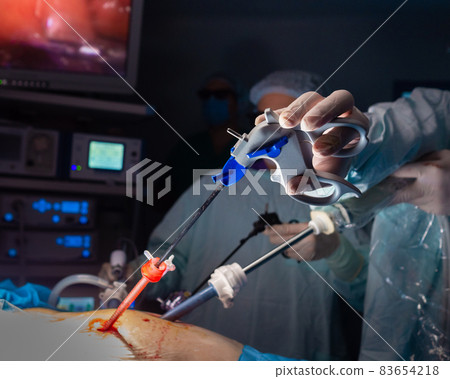 The hand of a surgeon holding a medical instrument during surgery. The hand of a surgeon holding a medical instrument during surgery. 83654218