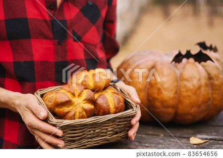 Young woman and her baby son in autumn park, boy playing with helloween pumpkin and eating pumpkin Young woman and her baby son in autumn park, boy playing with helloween pumpkin and eating pumpkin 83654656