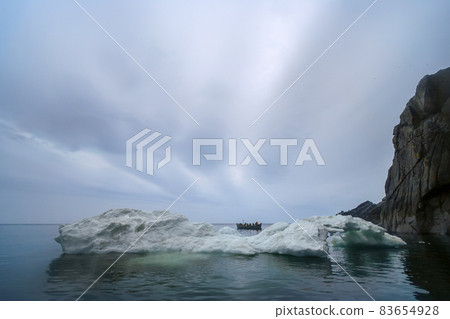 Arctic landscape with a whaleboat among the ice floes in the Bering Strait. Arctic landscape with a whaleboat among the ice floes in the Bering Strait. 83654928