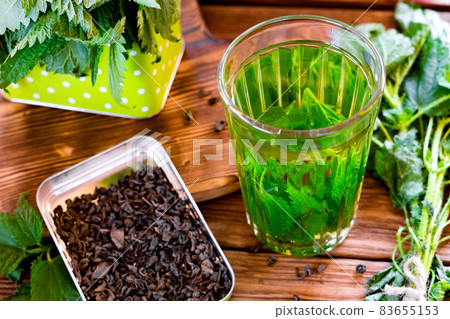 Nettle tea in glass, fresh and dry nettle. Herbal tea.  83655153