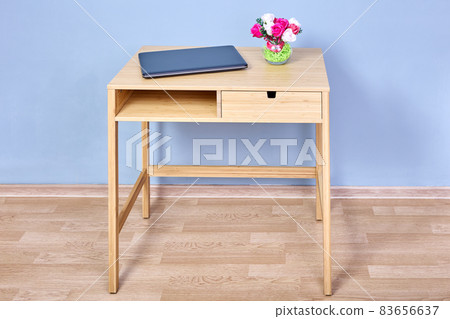 Modern wood console table with storage against blue wall. 83656637