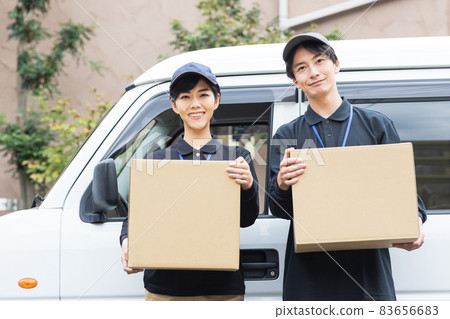 Delivery driver carrying luggage Delivery driver carrying luggage 83656683