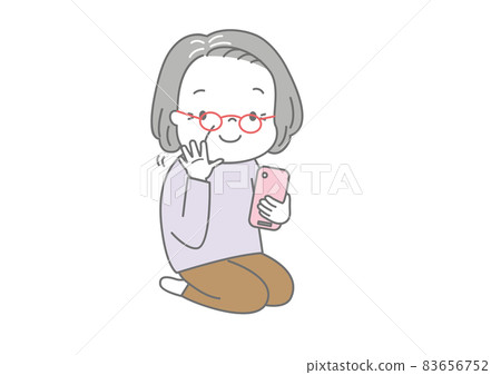 Grandmother waving while making a video call on her smartphone Grandmother waving while making a video call on her smartphone 83656752