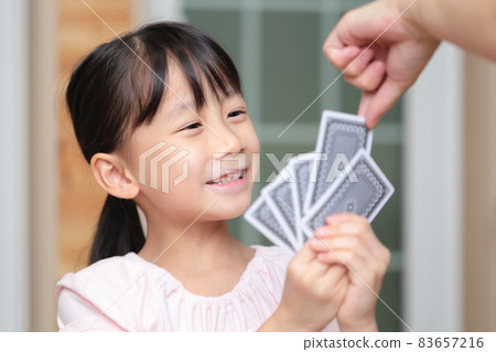 Girl playing cards to maid 83657216