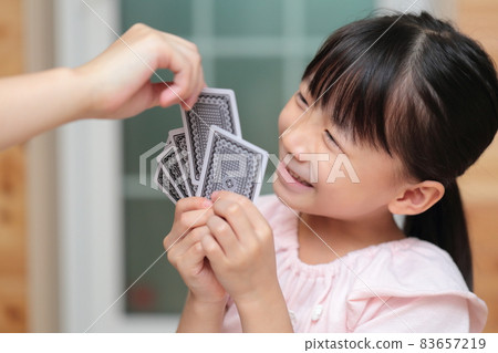 Girl playing cards to maid 83657219