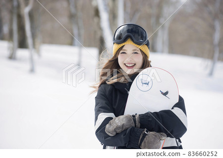 年輕女子捧著一個滑雪板 83660252
