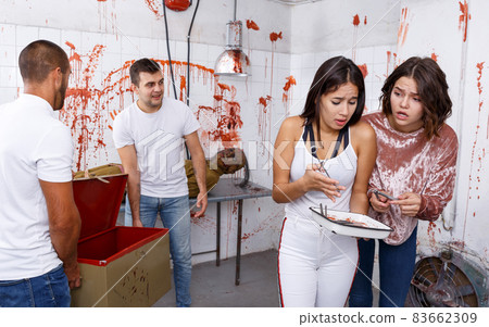 Frightened girls in escape room with traces of blood Frightened girls in escape room with traces of blood 83662309
