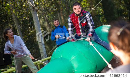 Man having fun on inflatable rodeo bottle Man having fun on inflatable rodeo bottle 83662414